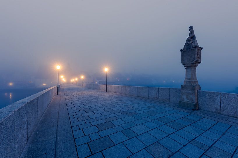 Stone bridge with Bruckmandl in Regensburg in the morning in autumn with fog by Robert Ruidl