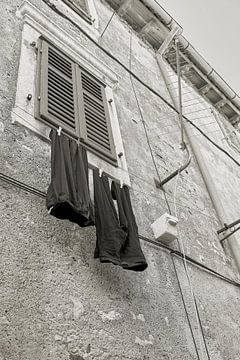 Clothesline with pants in the old town of Krk in Croatia by Heiko Kueverling