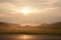 Warm sunrays with foggy landscape