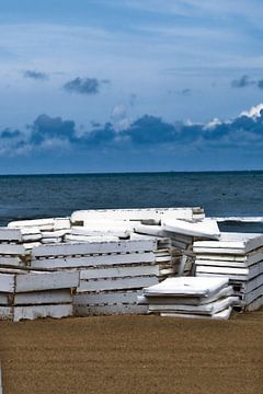 Picture of white decking on the beach. by Therese Brals