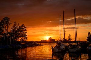 sunset in the harbor of de veenhoop in holland