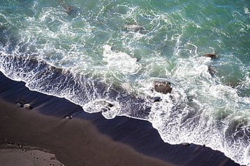 Waves ripple on a black beach by Maren Müller Photography