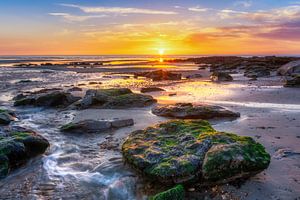 Sunset at beach with rocks