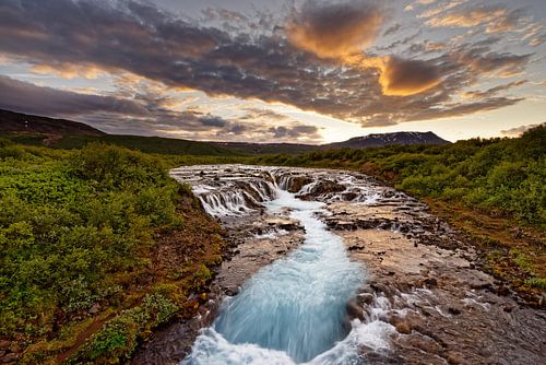 Waterfall in wild landscape after sunset