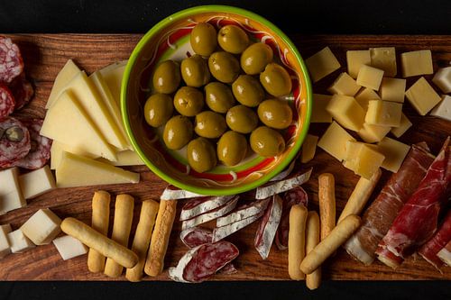 flat lay of tapas with olives, cheese and Spanish ham