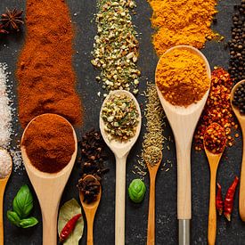 Spices and herbs on wooden ladles by Francis Dost