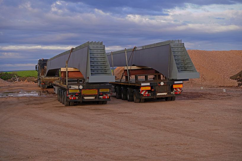 Arrival of heavy goods vehicles with bridge girders by Babetts Bildergalerie