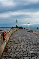 A pier on the Baltic Sea with a lighthouse