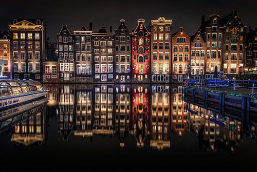 Amsterdamse Damrak in de avond