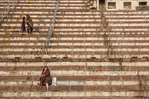 Indian woman on the riverbank of Ganges at sunny day in Varanasi, India