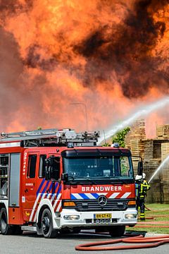 Fire engine in front of a fire in an industrial area by Sjoerd van der Wal Photography