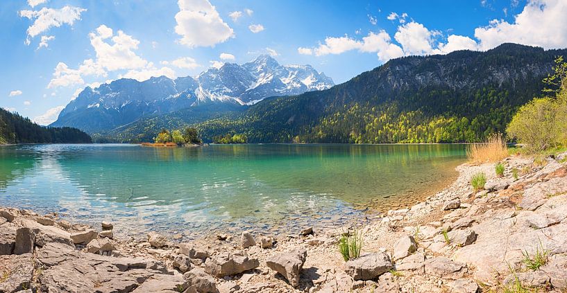 rocky bathing beach at lake shore Eibsee, view to Zugspitze moun by SusaZoom