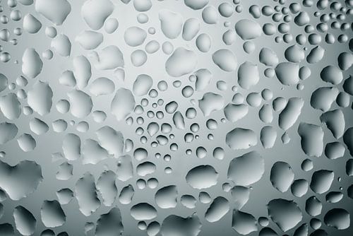 Abstract play of water drops on glass