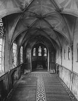 Abandoned monastery chapel space with dilapidated room walls and windows