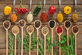 Fresh chilli, spices and herbs on wood