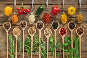 Frische Chili, Gewürze und Kräuter auf Holz