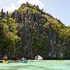 Boats in the water near El Nido cliffs (Philippines) by Jessica Lokker