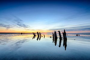 Poles standing in a colorful sunset