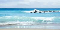 Azuurblauwe golven slaan neer op het strand van Tenerife.