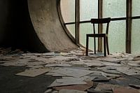 Chair and leaves lying around in abandoned church