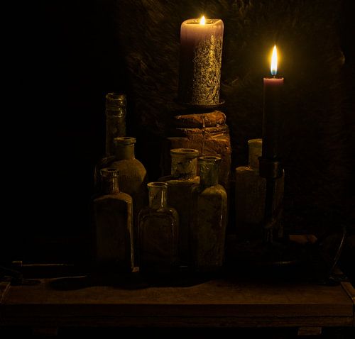 Still life with candles and bottles