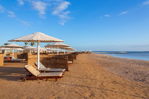 Beach with umbrellas and sunbeds at Red Sea in Hurghada, Egypt