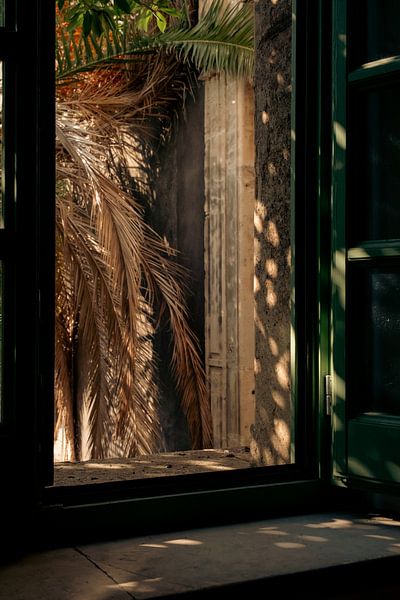 Sunlit Courtyard View through a Window in Catania, Italy by Cristina Cozari
