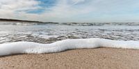 Schuim op het strand