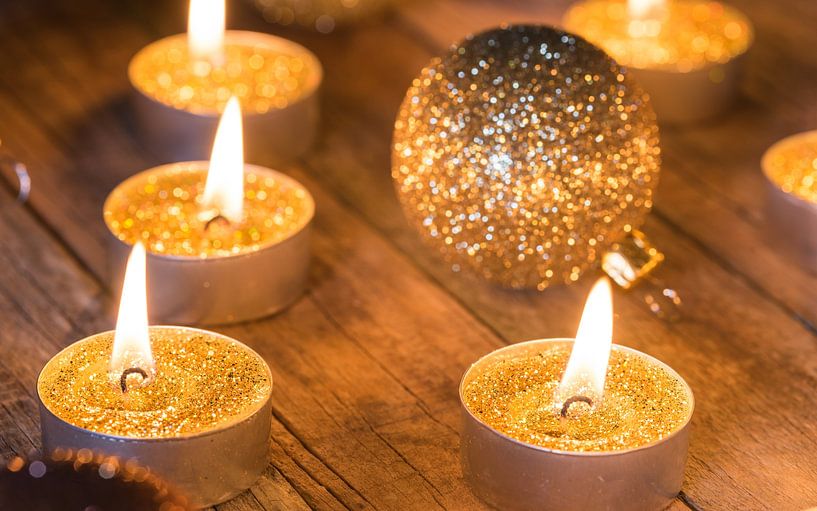 Shiny Christmas time Advent candles with golden glitter baubles decorations by Alex Winter
