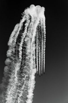 Airshow with flying squadron and smoke in cloudy sky in black and white by Dieter Walther