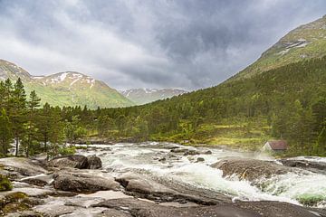 The Likholefossen waterfall with mountains in Norway by Rico Ködder