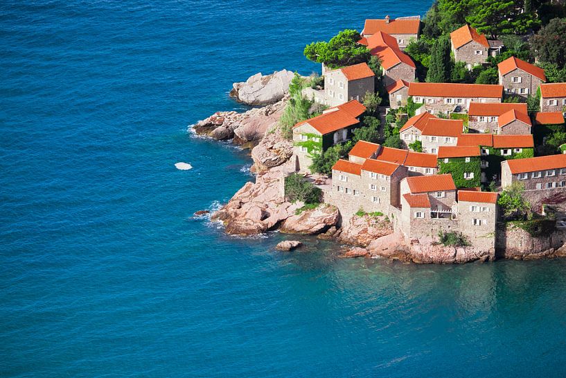 Mediterranean town. small houses with a tiled roof and green trees by the blue sea. happiness in rel by Michael Semenov