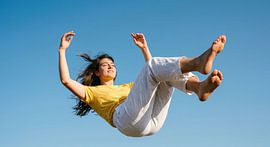 Joyful Jump Against Blue Sky by Markus Gann