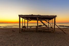 Old cottage on the beach by Frank Herrmann