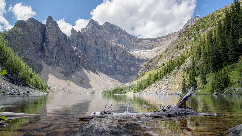 Canadian Rocky Mountains reflected in calm mountain lake by Arjen Tjallema