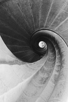 A spiral staircase leading into the light