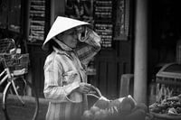 Market woman with non la in Hoi An, Vietnam