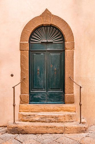 Elegant blue wooden door with stone edging and stairs
