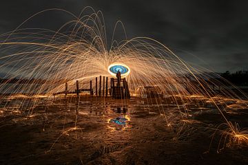 Fire sparks with burning steel wool in the night by Jolanda Aalbers