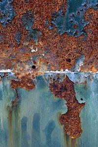 Steel surface with turquoise chipped paint and rusty background