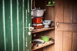 Authentic petroleum pots in an old-fashioned Dutch kitchen cabinet