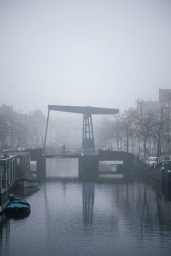 Cyclist on bridge in fog - atmospheric street photography
