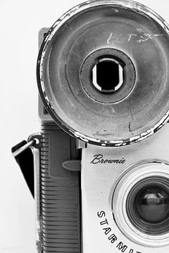 Photo of a detail of a retro camera in black and white.
