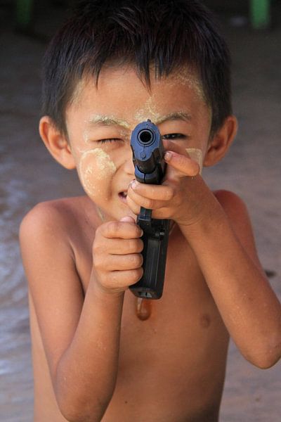 Little boy with toy gun in Myanmar by Gert-Jan Siesling