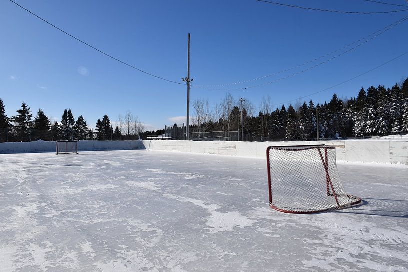 The village's ice rink in winter by Claude Laprise