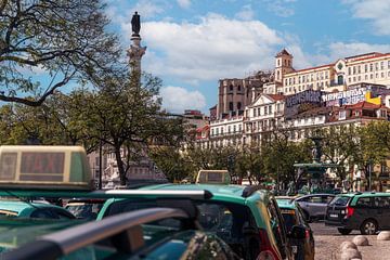 View over taxis to historic buildings in Lisbon by Jens Sessler