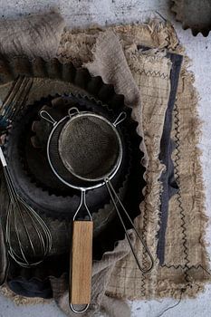 Sieve on an antique cake tin
