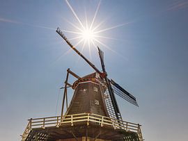 Pieterburen's windmill in the backlight of the sun by Harrie Muis