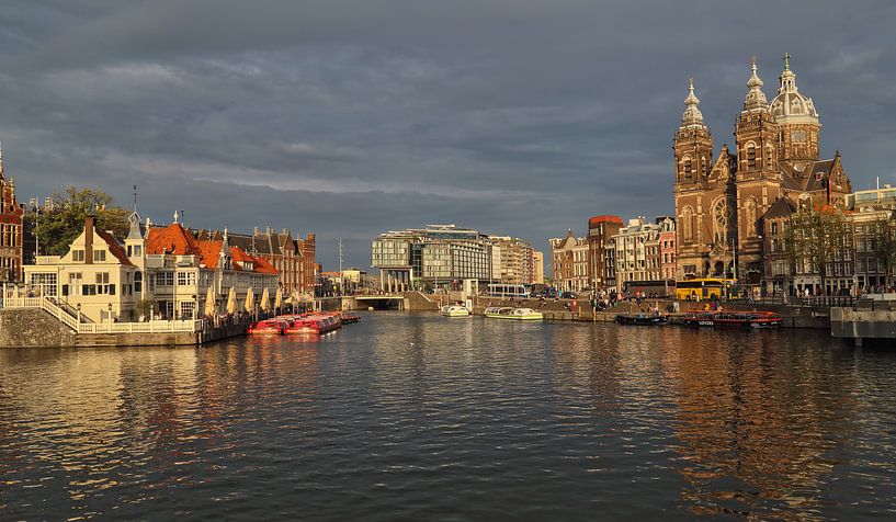 Saint Nicholas church and other buildings in the light of the sunset on a canal in Amsterdam, The Ne by Jan Kranendonk