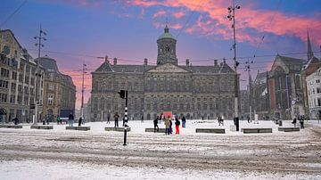 Snow-covered Amsterdam on Dam Square in the Netherlands in winter at sunset by Eye on You